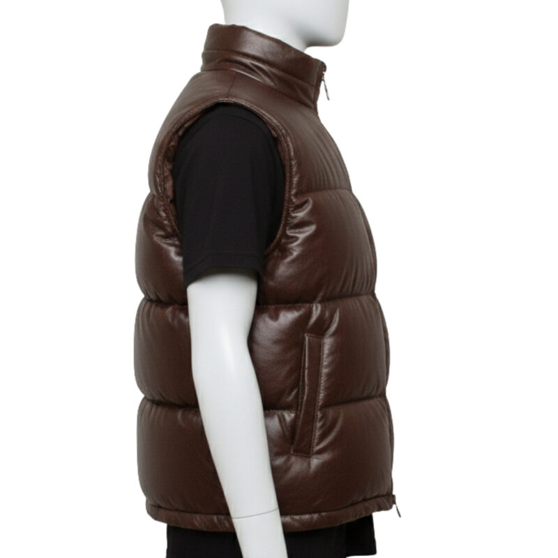 Detailed texture of the premium full-grain black leather on a wide-baffle puffer vest.