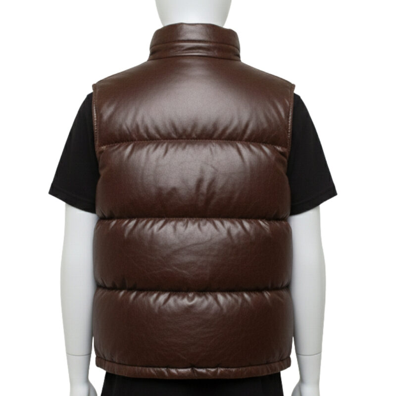 Detailed texture of the premium full-grain black leather on a wide-baffle puffer vest.