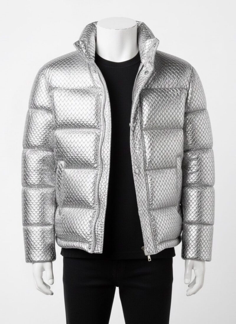 A man wearing a Custom Jackets USA metallic silver woven puffer jacket with horizontal quilting and a high stand collar against a clean white background.