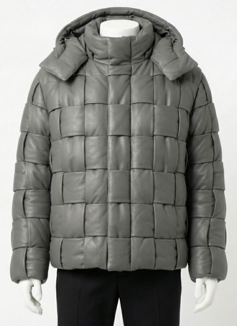 A man wearing a Custom Jackets USA grey oversized woven leather puffer jacket featuring a high collar and heavy quilting against a light background.