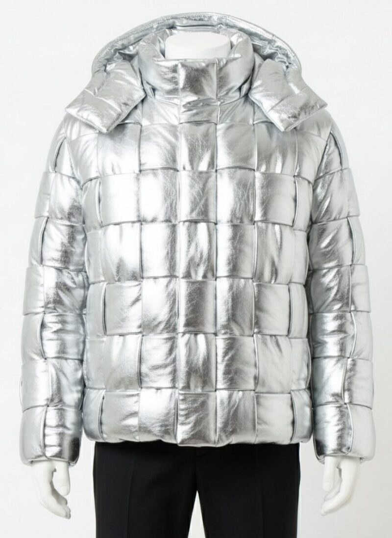 A man wearing a Custom Jackets USA metallic silver leather puffer jacket with a woven square pattern and high collar.