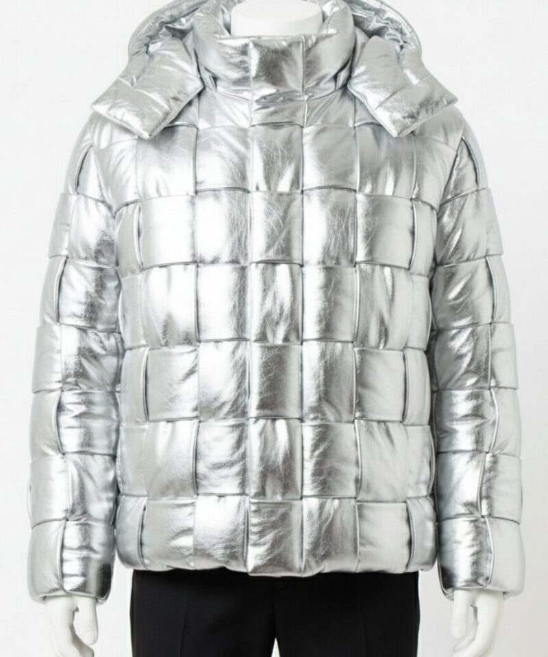 A man wearing a Custom Jackets USA metallic silver leather puffer jacket with a woven square pattern and high collar.