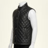 Detailed view of the diamond quilting and snap button closure on a leather puffer vest.