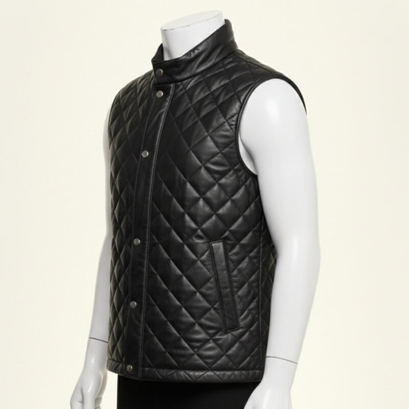 Detailed view of the diamond quilting and snap button closure on a leather puffer vest.