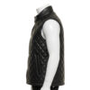 Detailed view of the diamond quilting and snap button closure on a leather puffer vest.