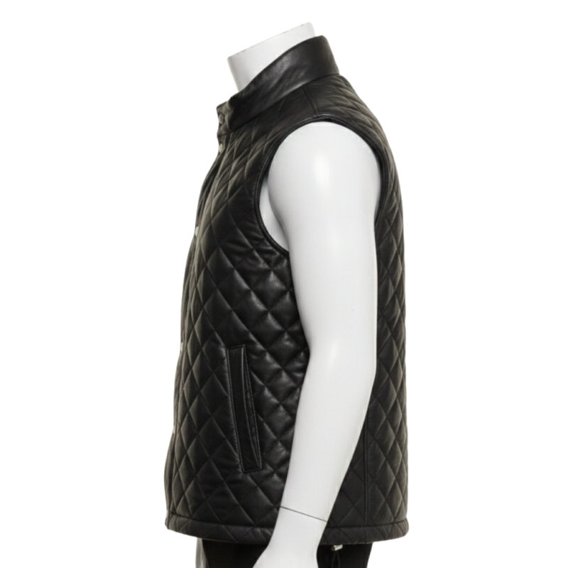 Detailed view of the diamond quilting and snap button closure on a leather puffer vest.