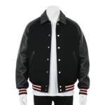A man wearing a black and white leather varsity jacket with a wool body and snap buttons.
