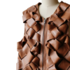 A high-resolution image of a cinnamon woven garment showcasing a leather long vest women design for luxury wear.