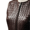 A handcrafted burnt coffee braided leather body warmer women showing the womens black leather vest texture.